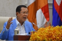 FILE - Cambodia's Prime Minister Hun Sen speaks during a press conference at the Peace Palace in Phnom Penh, April 7, 2020.