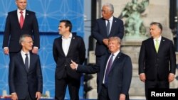 NATO Secretary General Jens Stoltenberg, Poland's President Andrzej Duda, Greek Prime Minister Alexis Tsipras, U.S. President Donald Trump, Portugal's Prime Minister Antonio Costa, Hungarian Prime Minister Viktor Orban pose for a group photo in the park o