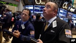 Trader Christopher Morie, right, works on the floor of the New York Stock Exchange Monday, Sept. 16, 2013. U.S. stocks and bonds are rising sharply in early trading after former Treasury Secretary Larry Summers withdrew from the race to become head of the