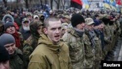 Members of self-defense battalions take part in a rally to commemorate demonstrators who were killed during the Maidan protests in 2014 in Kiev, Ukraine, Feb. 20, 2016.