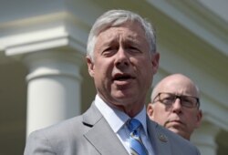 FILE - Congressman Fred Upton, R-Mich., left, speaks to reporters outside the White House in Washington, May 3, 2017.