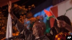 FILE - Roch Marc Kabore, winner of Burkina Faso's presidential election, celebrates as supporters gather outside his campaign headquarters in Ouagadougou, Dec. 1, 2015.