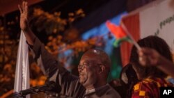 Roch Marc Christian Kabore, winner of Burkina Faso's presidential election, celebrates as supporters gather outside his campaign headquarters in Ouagadougou, Dec. 1, 2015.