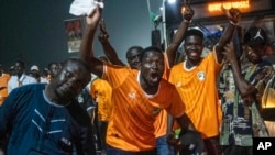 Ivory Coast supporters cheer after their team won the African Cup of Nations against Nigeria in Abidjan, Ivory Coast, Feb. 11, 2024.