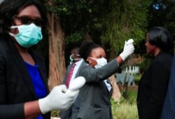 Health workers screen visitors to prevent the spread of coronavirus disease (COVID-19) at State House in Harare, Zimbabwe, March 19, 2020.