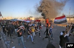 FILE - Iraqi protesters take part in a demonstration against state corruption, failing public services and unemployment, in Baghdad's central Khellani Square, Oct. 4, 2019.