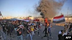 FILE - Iraqi protesters take part in a demonstration against state corruption, failing public services, and unemployment, in the Iraqi capital Baghdad's central Khellani Square, Oct. 4, 2019. 
