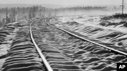 FILE - Snow ripples over railroad ties on the then-new Bailkal-Amur Mainline railway in the far east of Russia in 1978. A Ukrainian source said on Dec. 1, 2023, that its spy agency detonated explosives on the railway line to disrupt military supply routes.