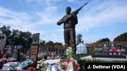 FILE - The grave of a Bosnian Serb soldier. All sides are meticulous in tending the graves of the dead from the Balkan wars of the 1990s that erupted as Yugoslavia fractured. 