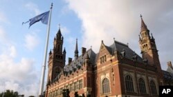 A United Nations flag flutters in the wind next to the International Court of Justice in the Hague, the Netherlands, Aug. 27, 2018. Iran is pressing the court to have U.S. sanctions against Tehran lifted.