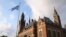 FILE - A United Nations flag flutters in the wind next to the International Court of Justice in the Hague, the Netherlands, Aug. 27, 2018.