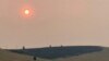 Smoke obscures the air and dims the sun over a hillside burned by a recent wildfire, in Missoula, Mont., on Sunday, July 18, 2021. Extreme heat descended on parts of the U.S. northern Rocky Mountains on Monday, July 19 as authorities struggled to…