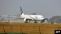 FILE - A Pakistan International Airline (PIA) plane taxis on the runway on the way to Saudi Arabia, Feb. 8, 2016. 