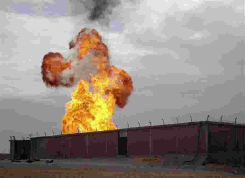 Flames are seen after an explosion went off at a gas terminal in Egypt's northern Sinai Peninsula, February 5, 2011, in El-Arish, setting off a massive fire