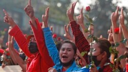 Protesters flash the three-fingered salute in Yangon, Myanmar, Feb. 7, 2021. Thousands of people rallied against the military takeover and demanded the release of Aung San Suu Kyi.