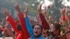 Protesters flash the three-fingered salute in Yangon, Myanmar, Feb. 7, 2021. Thousands of people rallied against the military takeover and demanded the release of Aung San Suu Kyi.