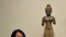 Dr. Melody Rod-ari stands near Khmer statues at the "Where Art Meets Science" exhibition at Norton Simom Museum in Pasadena, California on July 1, 2011. Where Art Meets Science exhibition displays ancient sculptures from the Hindu-Buddhist World.