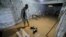 FILE —A man stands in the flooded basement of a home in Libya's coastal city of Zliten, 150 kilometers east of the capital on February 13, 2024, as a result of rising groundwater levels. 