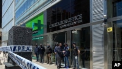 Police guard the entrance to Dr. Leopoldo Luque's practice in Buenos Aires, Argentina, Nov. 29, 2020. Luque was Diego Maradona's personal doctor, and his house and offices were raided Sunday amid investigations into the famed footballer's death.