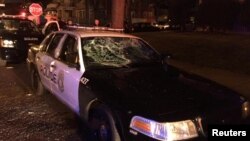 A police car with broken windows is seen in this photograph released by the Milwaukee Police Department after disturbances following the police shooting of a man in Milwaukee, Wisconsin, Aug. 13, 2016.