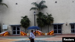 A man walks with an umbrella ahead of Tropical Storm Elsa in the Little Havana neighborhood of Miami, Florida, July 5, 2021. 