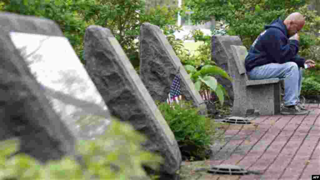 Michael McKee pauses Monday, May 2, 2011, in Middletown, New Jersey, as he sits among some of the 37 carved stone memorials in a garden that honors those from the town that died in the attacks on the World Trade Center on Sept. 11, 2001 (AP)
