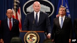 Acting Attorney General Matt Whitaker, center, with Commerce Secretary Wilbur Ross, left, and FBI Director Christopher Wray speak, Jan. 28, 2019, at the Justice Department in Washington. 
