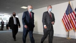 FILE - Senate Republican Majority Leader Mitch McConnell, left, and Republican Sen. Lindsey Graham, both wearing face masks to protect against the coronavirus walk on Capitol Hill, in Washington, May 19, 2020.