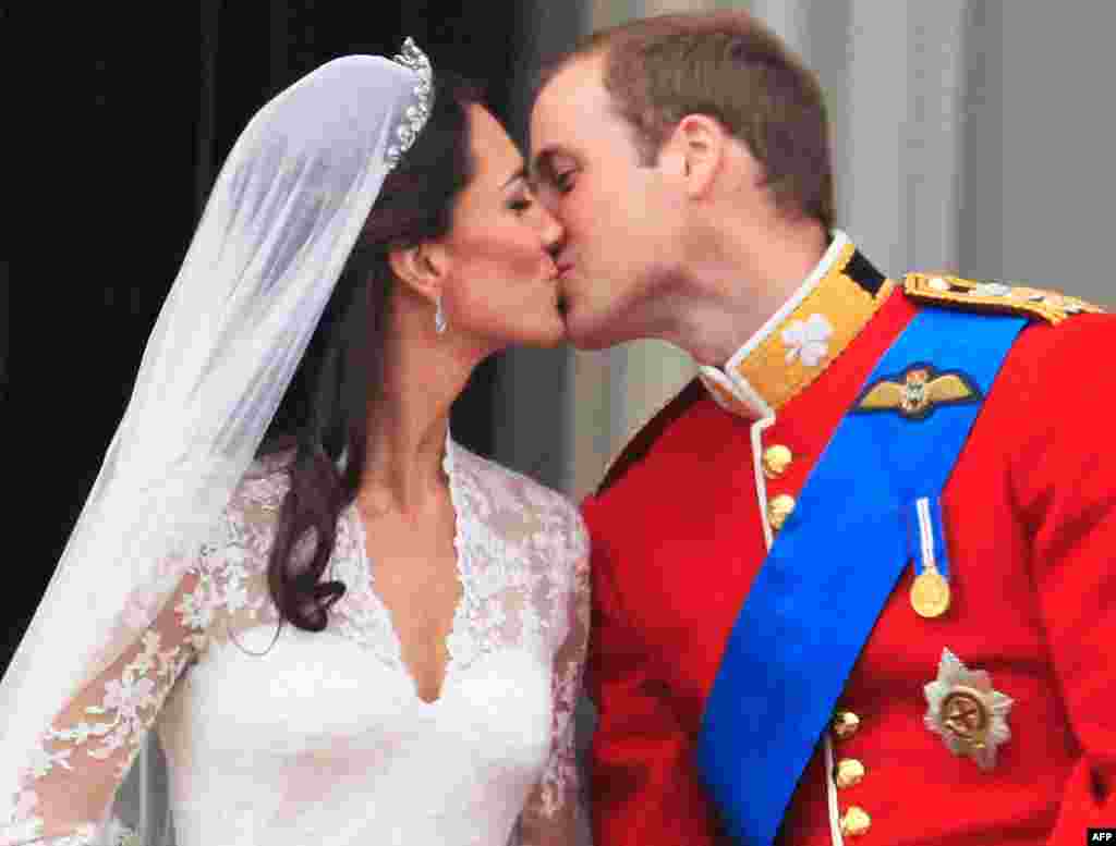 The first kiss: Prince William kisses his wife Kate, Duchess of Cambridge on the balcony of Buckingham Palace. (AP Photo)