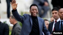 FILE PHOTO: Brazilian soccer legend Pele waves during the international friendly soccer match between Algeria and Slovenia in Algiers