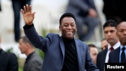 FILE PHOTO: Brazilian soccer legend Pele waves during the international friendly soccer match between Algeria and Slovenia in Algiers