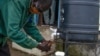 FILE - A community health worker washes hands in South Sudan on Aug. 18, 2020. Washing hands helps prevent infections. 