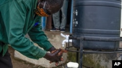 FILE - A community health worker washes hands in South Sudan on Aug. 18, 2020. Washing hands helps prevent infections. 