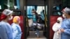 Una mujer que dio positivo por COVID-19 llega en un autobús del gobierno a una antigua residencia de estudiantes que se utiliza para poner en cuarentena a pacientes asintomáticos infectados con el nuevo coronavirus en Caracas, Venezuela, el martes 25 de a