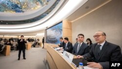 Kepala Misi China untuk PBB di Jenewa Chen Xu (kanan) duduk dengan dokumen sebelum peninjauan catatan hak asasi manusia China oleh Dewan Hak Asasi Manusia PBB di Jenewa, 23 Januari 2024.