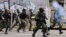 FILE - Security forces charge on anti-government protesters in Caracas, Venezuela, July 22, 2017.