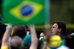 Brazil's President Jair Bolsonaro celebrates his 66th birthday with supporters at the Alvorada Palace, the official presidential residence, in Brasilia, Brazil, March 21, 2021.