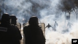 Police in a town near Paris use teargas to disburse protesters demonstrating against a plan to increase the French retirement age, 20 Oct 2010