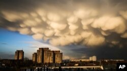 Clouds cover the sky over the Ernst-Taehlmann-Park housing estate after a thunderstorm in Berlin, Germany, Thursday, March 11, 2021. (AP Photo/Markus Schreiber)