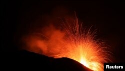 FILE - Lava spurts from the Stromboli volcano a day after an eruption unleashed a plume of smoke on the Italian island of Stromboli, Italy, Aug. 30, 2019.