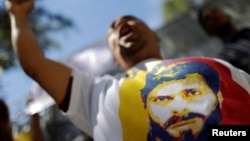 A supporter of jailed opposition leader Leopoldo Lopez shouts slogans, Dec. 6, 2016, during a protest calling for the government of Venezuela's President Nicolas Maduro to order the release of political prisoners. On Tuesday, Dec. 13, 2016, four opponents of Maduro were released. 