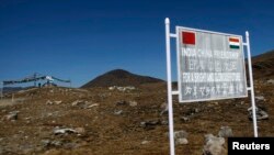 FILE - A sign is posted on the Indian side of the Indo-China border at Bumla, in the disputed Indian state of Arunachal Pradesh.