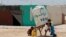 Syrian refugees children collect water at the Al-Zaatari refugee camp in Mafraq, Jordan, near the border with Syria, May 30, 2016.