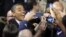 President Barack Obama smiles for cameras as he shakes hands with supporters after speaking at a campaign event at Nationwide Arena in Columbus, Ohio, Nov. 5, 2012.