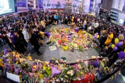 People gather at a memorial for Kobe Bryant near Staples Center Monday, Jan. 27, 2020, in Los Angeles.