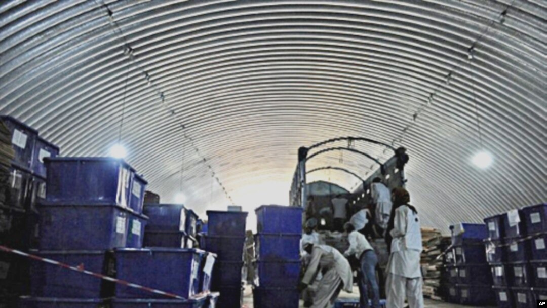 Afghan workers of the Independent Election Commission (IEC) load ballot boxes onto a truck to be distributed to polling stations from a warehouse in Kabul, 14 Sept. 2010