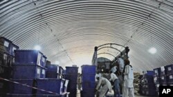 Afghan workers of the Independent Election Commission (IEC) load ballot boxes onto a truck to be distributed to polling stations from a warehouse in Kabul, 14 Sept. 2010