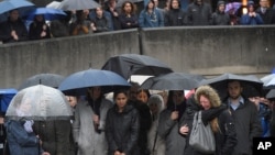 People near the scene of the recent attack observe a minute's silence in tribute to the victims of the attack at London Bridge and Borough Market, in central London, June 6, 2017. 