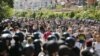 FILE - Interior Ministry members stand guard as activists take part in the LGBT Equality March in Kyiv, Ukraine, June 6, 2015.