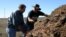 Jeffrey Creque (L) examines MCP Demonstration Ranch partner Loren Poncia’s (R) compost at the Stemple Creek Ranch prior to application. 